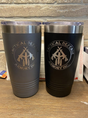 Two insulated tumblers, one gray and one black, featuring "Tactical Defense Armory Inc." logos on the front. These Kodiak Coolers Custom Tumblers 20 oz with your Logo or Design Engraved - Special Bulk Wholesale Pricing - Pack of 12 Pieces - 1 Color are perfect for showcasing your brand with durability and style.