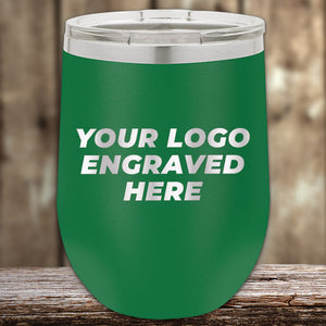 A green Kodiak Coolers travel mug, featuring a laser-etched design with "Your Logo Engraved Here" text, perfect for corporate promotional gifts, sits elegantly on a wooden surface against a blurred wooden backdrop.