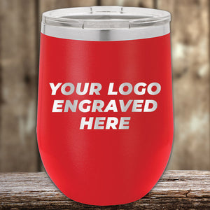 A red Kodiak Coolers insulated tumbler with a metal lid rests on wood. This Custom Tumbler with Logo Engraved offers laser-etched design, making it an ideal corporate promotional gift.