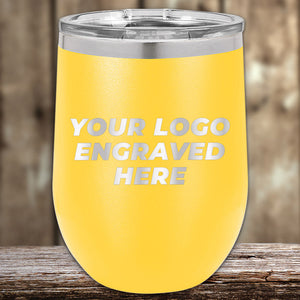 A yellow insulated tumbler from Kodiak Coolers, featuring a laser-etched "YOUR LOGO ENGRAVED HERE," is ideal for corporate gifts. Sitting on wood with a blurred background, it exemplifies the elegance of custom tumblers. Enjoy no setup fees and a limited-time offer with this promotion.