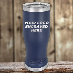 A blue stainless steel tumbler with a silver lid sits on a wooden surface. The words "Custom Pilsner Tumblers 14 oz with your Logo or Design Engraved | No Minimal Order | Sample Volume Pricing" from Kodiak Coolers are printed on its side. Ideal for those seeking bulk wholesale pricing, the background features a wooden texture.