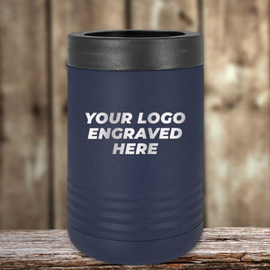 A Kodiak Coolers blue insulated tumbler with a black lid, featuring "Your Logo Engraved Here" in white against a blurred wooden background, is perfect as a custom promotional gift. Enjoy laser-etched design and no setup fees for a limited time offer.