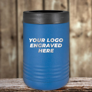 A blue Kodiak Coolers tumbler sits elegantly on wood, laser-etched with "Your Logo Engraved Here" in white. Ideal for corporate gifts, this custom tumbler is showcased against a blurred wooden background. No setup fees and limited time offer available.