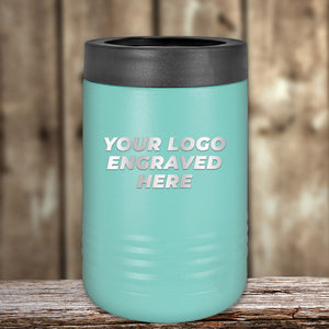 A teal Custom Tumbler from Kodiak Coolers, with a black lid and laser-etched "Your Logo Engraved Here" text, rests on wood. Ideal for corporate gifts, this limited-time offer boosts brand recognition with every sip. No setup fees included.