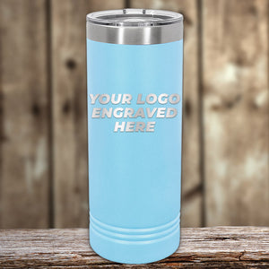 A tall, light blue tumbler with a metal top from Kodiak Coolers features "Your Logo Engraved Here" against a wooden background, making it an ideal corporate promotional gift.