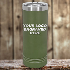 Kodiak Coolers' green stainless steel tumbler with laser-etched "YOUR LOGO ENGRAVED HERE" rests on wood; ideal for corporate gifts. Limited time offer, no setup fees with Custom Tumblers.