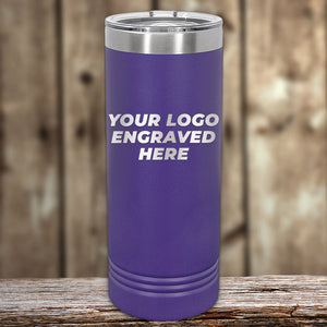 The Kodiak Coolers' purple stainless steel tumbler, ideal for corporate gifts, elegantly rests on wood. Its laser-etched "YOUR LOGO ENGRAVED HERE" design adds personalized style against a blurred wooden backdrop.