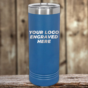 A Kodiak Coolers blue cylindrical tumbler with a metal lid sits on wooden surface, boasting "Your Logo Engraved Here" text. Its laser-etched design makes it an ideal corporate gift. The blurred wooden texture background enhances its appeal as one of the finest engraved tumblers. No setup fees, limited time offer!.