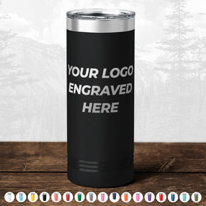 The Kodiak Coolers' Custom Drinkware, featuring "Your Logo Engraved Here" text, is showcased on a wooden surface. The background presents a faint image of mountains and trees. Various color options are displayed in a row at the bottom, making this engraved mug an ideal choice for any promotional gift need. Don't miss out on the HUGE LABOR DAY SALE - ENDS TODAY!