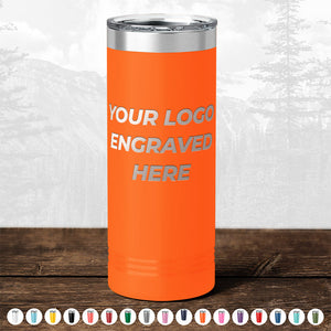 An orange insulated tumbler from Kodiak Coolers, featuring the text "Your Logo Engraved Here," is showcased on a wooden surface against a mountainous backdrop. This promotional item, part of the BLACK FRIDAY SALE on custom drinkware, offers various color options for your personalized mugs without any setup fee and includes engraving on one side of the tumbler. Note: A minimum order of $250 is required.