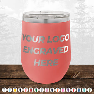 A pink insulated tumbler with "Kodiak Coolers 4th of July SALE - Engraved Custom Logo Drinkware - Front Engraved Logo Included - $250 Minimal Order" on the front, displayed on a wooden surface alongside various color options. Perfect for personalized mugs or promotional gifts, this tumbler makes an excellent choice for showcasing custom logo mugs.