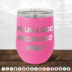 A pink insulated tumbler with the text "4th of July SALE - Engraved Custom Logo Drinkware - Front Engraved Logo Included - $250 Minimal Order" displayed on the side. Various color options are shown below the tumbler. Set against an outdoor scene, this is an ideal choice for personalized mugs as promotional gifts by Kodiak Coolers.