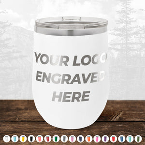 White tumbler with "Your Logo Engraved Here" text, featuring a silver lid, placed on a wooden surface. A selection of twelve colored icons is displayed below the tumbler. Perfect for promotional gifts or custom logo mugs to enhance your brand presence. Product Name: 4th of July SALE - Engraved Custom Logo Drinkware - Front Engraved Logo Included - $250 Minimal Order by Kodiak Coolers.