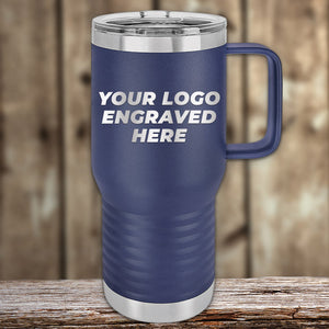 A Kodiak Coolers Custom Tumbler sits on a wooden surface, its blue insulated design with a handle makes it the perfect corporate promotional gift. It is laser etched with "YOUR LOGO ENGRAVED HERE," ensuring practicality and personalization. Take advantage of our limited-time offer with no setup fees.