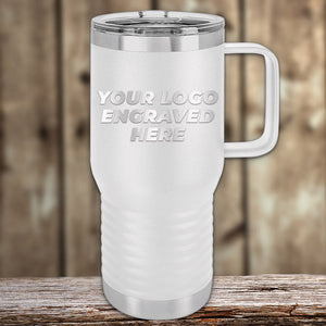 The Kodiak Coolers white insulated travel mug, ideal for corporate promotional gifts, displays "Your Logo Engraved Here." It rests on a wooden surface against a blurred backdrop. This custom tumbler features a laser etched design with no setup fees as part of a limited-time offer.