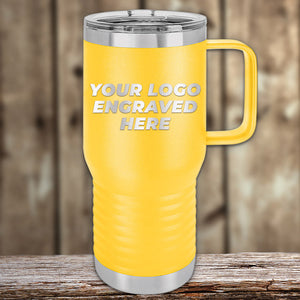 A yellow travel mug with a silver lid and handle rests on a wooden surface, perfect for corporate gifts. Displaying "Your Logo Engraved Here," these Custom Tumblers from Kodiak Coolers, with laser-etched design and no setup fees, are ideal for stylish customization.