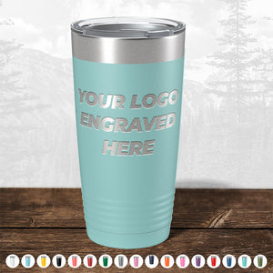 A light blue travel tumbler from Kodiak Coolers featuring the words "Your Logo Engraved Here." Various color options are shown in small circles below the tumbler, making it a perfect corporate promotional gift. These Custom Tumblers with Logo Engraved offer a laser-etched design with no setup fees and fast turnaround. FLASH SALE - ENDING SOON!