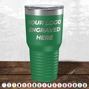 A green insulated tumbler from Kodiak Coolers, featuring the text "YOUR LOGO ENGRAVED HERE" on it, set against an outdoor-themed background. This personalized Custom Drinkware Engraved with your Logo or Design comes in various color options displayed at the bottom of the image, making it an ideal promotional gift. Don't miss out on the HUGE LABOR DAY SALE – ENDS TODAY!