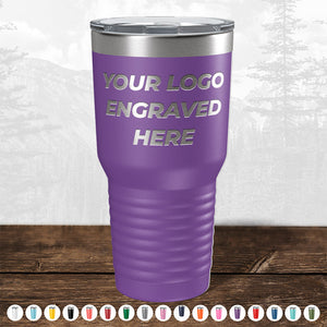 Kodiak Coolers' Custom Drinkware featuring your logo engraved on the front side sits on a wooden surface, with assorted color options displayed below against an outdoor background. Perfect for logo promotional gifts, don't miss out on today's HUGE LABOR DAY SALE!