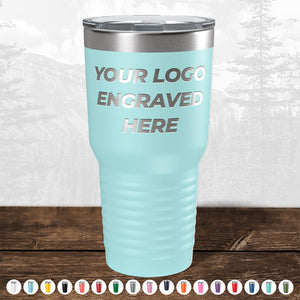 A light blue insulated tumbler from Kodiak Coolers, featuring a metal lid and the text "Your Logo Engraved Here" on the front side, is highlighted among numerous colored options displayed underneath. This custom drinkware is perfect as a personalized mug or promotional gift and is currently available in the HUGE LABOR DAY SALE - ENDS TODAY!