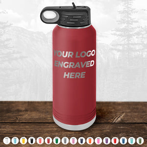 A red insulated water bottle with a black cap, placed on a wooden surface, showcasing the text 'YOUR LOGO ENGRAVED HERE'. Below it, various colored caps are displayed. This stylish item from Kodiak Coolers is perfect as a promotional gift and can complement custom mugs in your personalized collection. Don't miss out on the HUGE LABOR DAY SALE - ENDS TODAY!