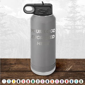 A gray insulated water bottle from Kodiak Coolers, featuring "Your Logo Engraved Here" on the front side, rests on a wooden surface, making it an ideal promotional gift. Displayed at the bottom are various color options against a nature-themed backdrop, beautifully highlighting the appeal of personalized drinkware. Don't miss out on the HUGE LABOR DAY SALE - ENDS TODAY!