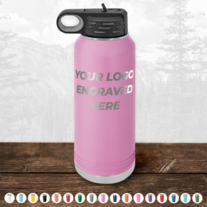 A pink Kodiak Coolers insulated water bottle with the text "Your Logo Engraved Here." It features a black lid and a handle, displayed against a mountain backdrop with various color options shown at the bottom. Perfect as a logo promotional gift, these bottles complement personalized mugs for any occasion. Special offer: Custom Drinkware Engraved with your Logo or Design - Front Side Logo Included - HUGE LABOR DAY SALE - ENDS TODAY!