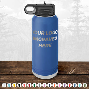 A striking blue insulated water bottle from Kodiak Coolers, featuring your logo engraved on the front, complete with a black lid and handle. Various color options are displayed at the bottom, and the background shows a scenic mountain landscape, making this personalized drinkware an ideal promotional gift. Don’t miss out on our HUGE LABOR DAY SALE - ENDS TODAY!