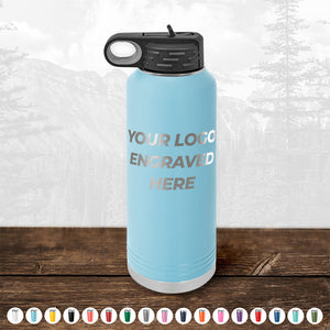 Blue insulated Kodiak Coolers custom water bottle with customizable logo space on a wooden surface.