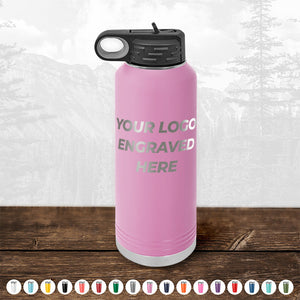 A pink engraved Custom Water Bottles 40 oz with your Logo or Design Engraved on a wooden surface by Kodiak Coolers.