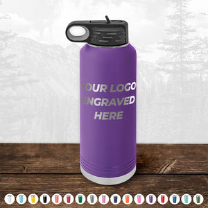 A Kodiak Coolers purple water bottle with an engravable logo area displayed on a wooden surface.