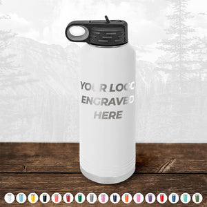 White Custom Water Bottles 40 oz with your Logo or Design Engraved - Low 6 Piece Order Minimal Sample Volume displayed on a wooden surface against a blurred wooden background by Kodiak Coolers.