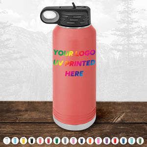 A red insulated water bottle with a black lid is displayed on a wooden surface. The bottle features text in rainbow colors that reads "YOUR LOGO UV PRINTED HERE." Ideal as a corporate promotional gift, multiple colored Custom Tumblers from Kodiak Coolers are shown at the bottom, available at bulk wholesale pricing for a limited time offer with a minimal order of $250.