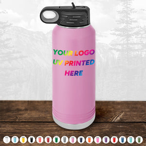 The Kodiak Coolers Custom Tumblers, UV printed with your logo or design in full color, are showcased on a wooden surface against a mountainous landscape with various color options displayed at the bottom. These pink reusable water bottles are ideal as corporate promotional gifts and available for a limited time offer with a minimal order of $250.