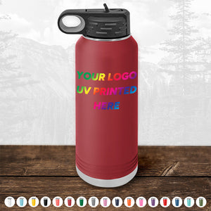 A red stainless steel water bottle from Kodiak Coolers, featuring a black screw cap and handle slot, personalized with customizable "Your Logo UV Printed Here" text. Multiple color options are shown below the bottle. Ideal as a corporate promotional gift, these custom tumblers are part of the Kodiak Coolers Custom Tumblers collection and are available at bulk wholesale pricing with a minimal order of $250 for a limited time.